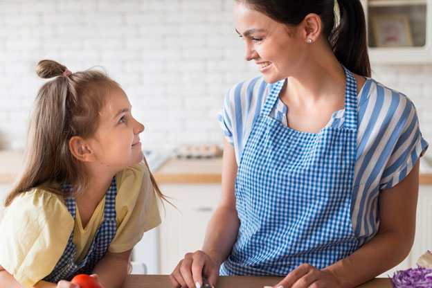 Happy Mother and Daughter In Kitchen