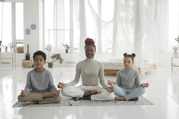 Mother meditating with kids